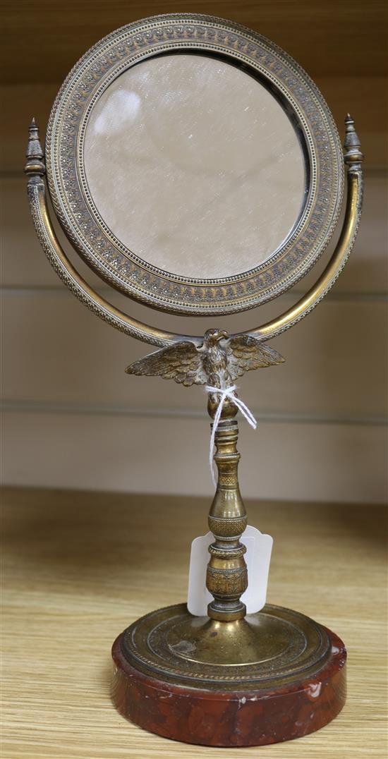 A 19th century French Empire style bronze shaving mirror, with eagle support, height 29cm